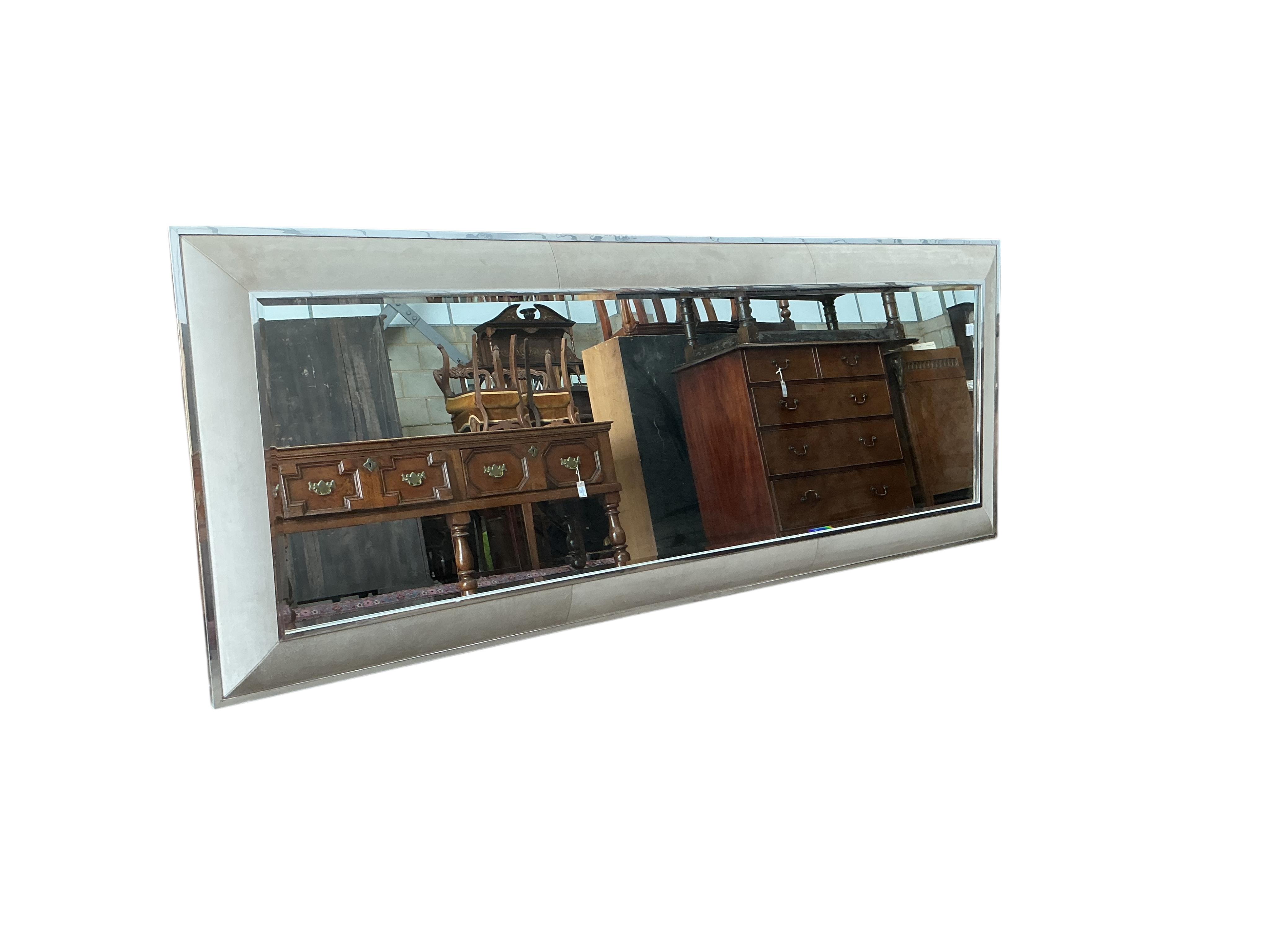 A large contemporary suede effect and chrome mirror, 280 x 100cm
